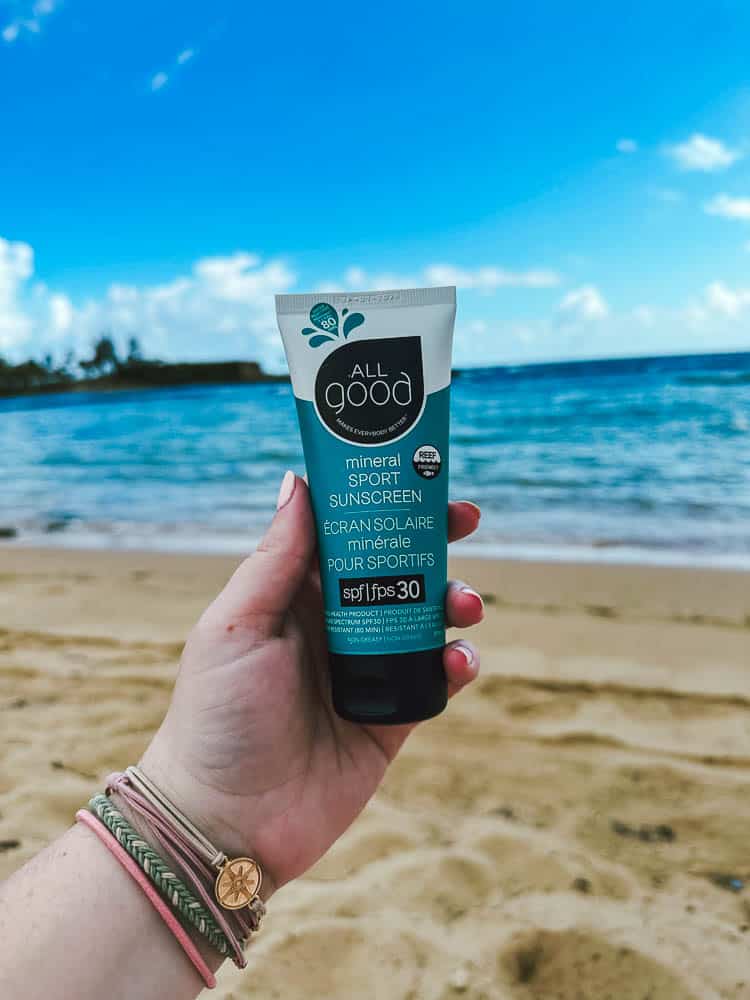 women holding a tube of All Good reef safe 30 SPF sunscreen